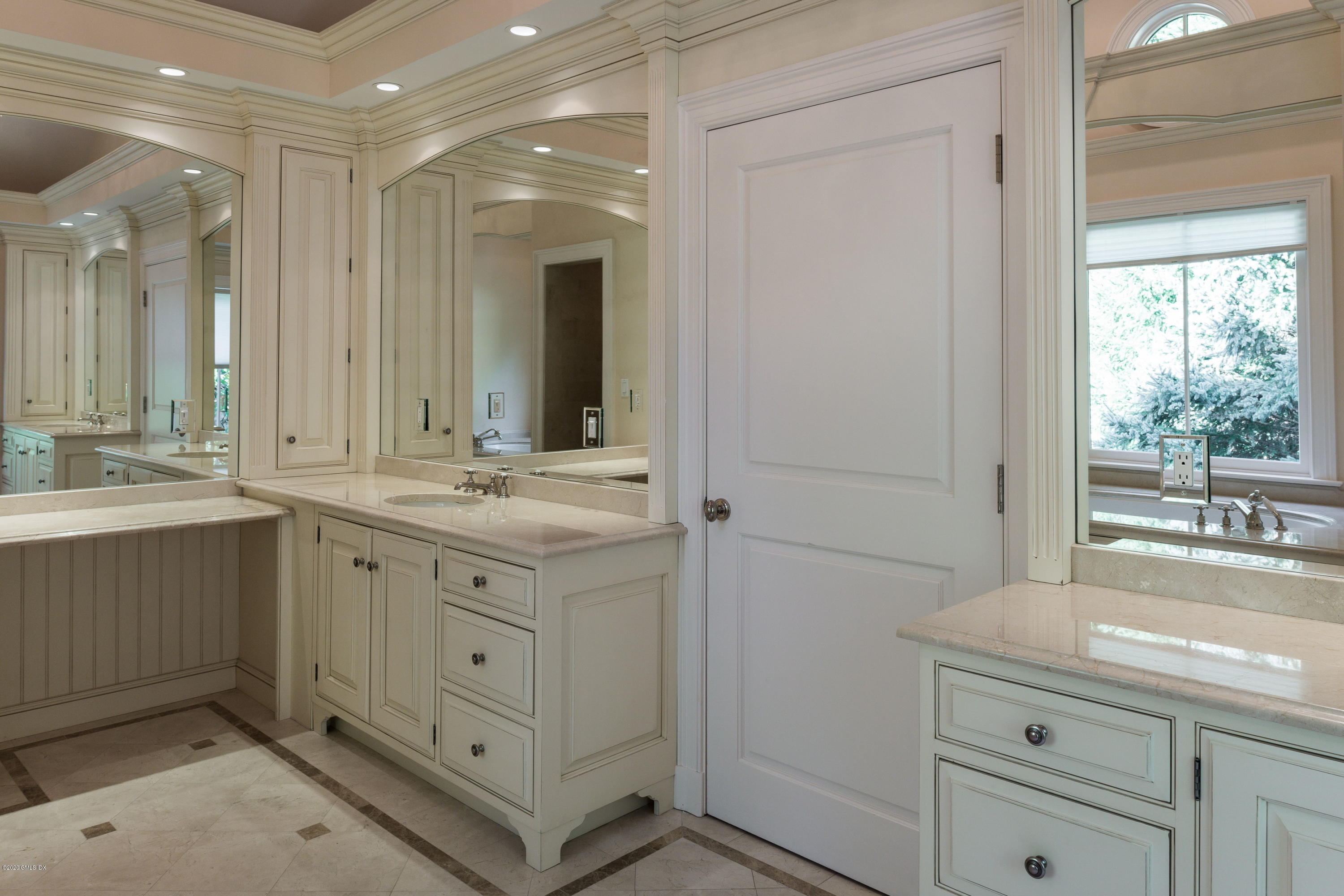 53 Hillside Road Greenwich, CT 06830 - Photo 22 of 31 a bathroom with a double vanity sink and a mirror
