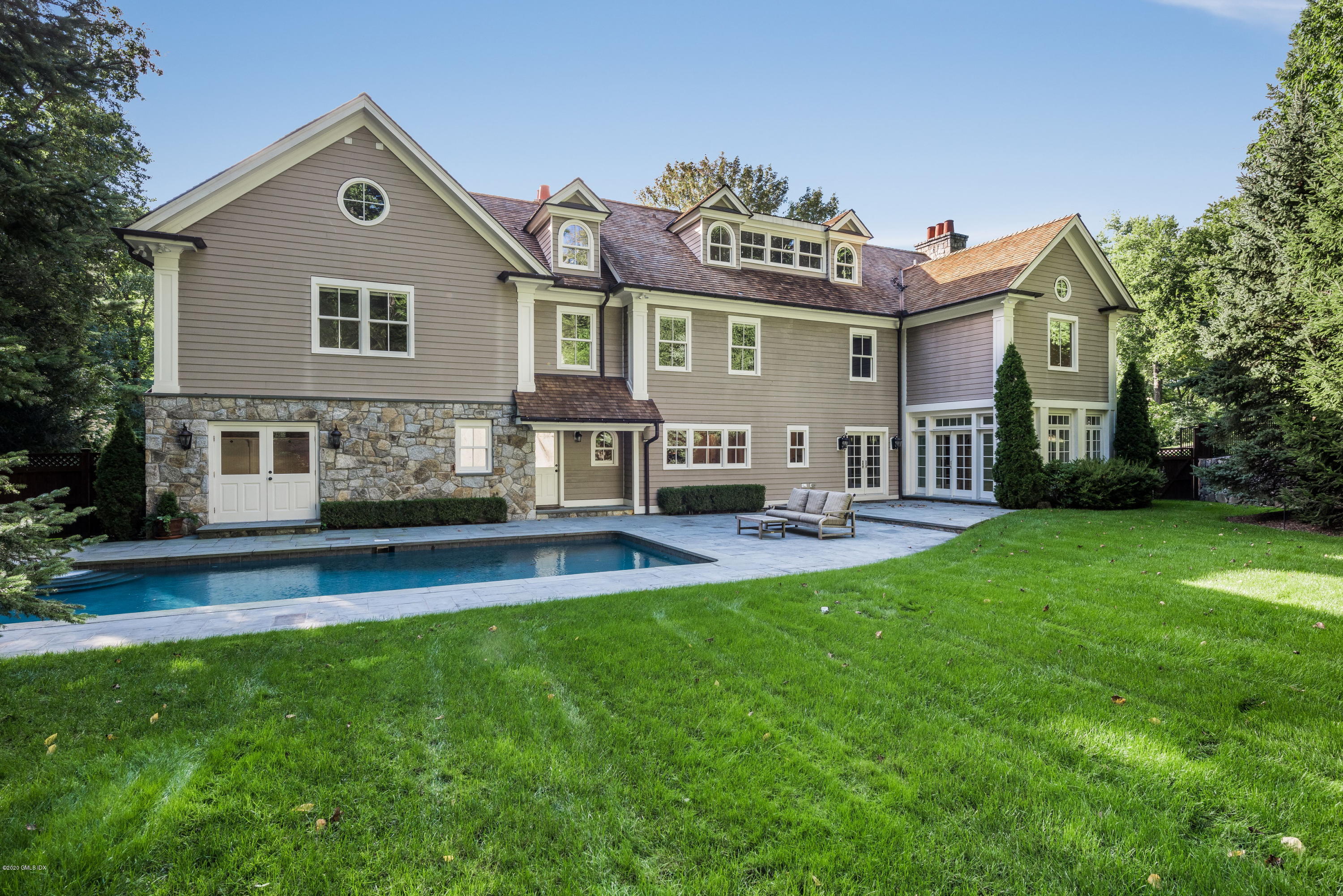 53 Hillside Road Greenwich, CT 06830 - Photo 30 of 31 a front view of house with yard and outdoor seating