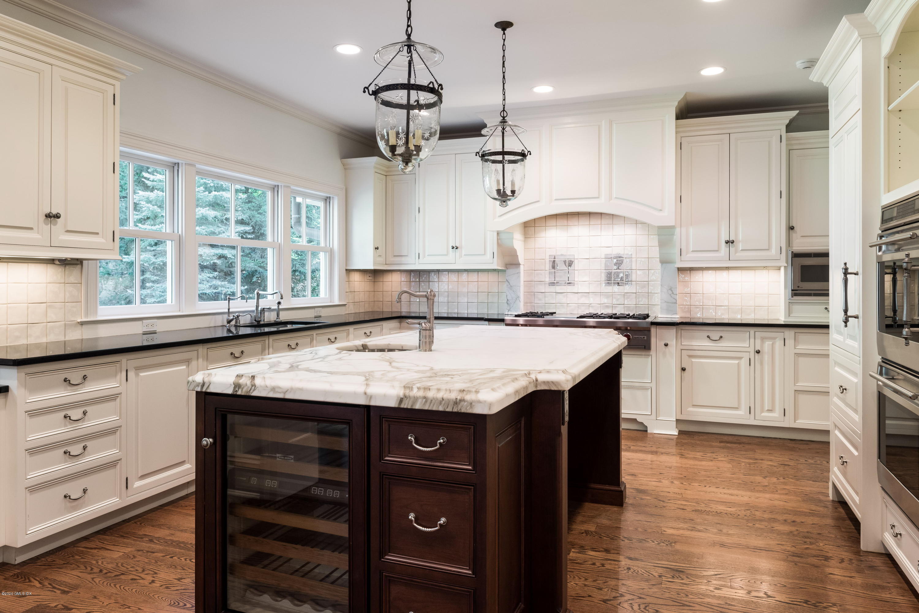 53 Hillside Road Greenwich, CT 06830 - Photo 9 of 31 a kitchen with granite countertop a sink a center island stainless steel appliances and cabinets