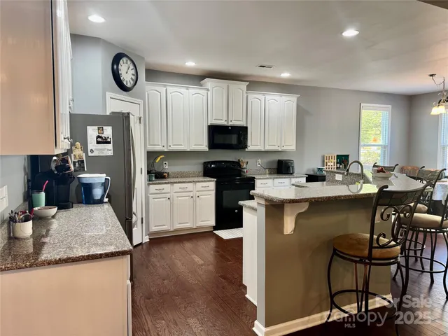 a kitchen with a sink cabinets and stainless steel appliances