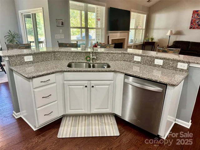 a kitchen with stainless steel appliances granite countertop a sink stove and cabinets