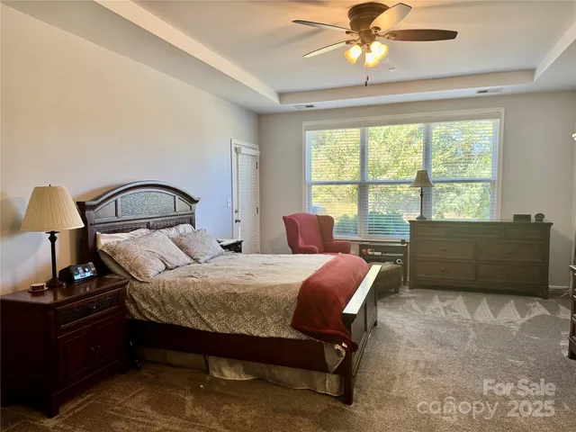 a bedroom with a bed window and a table