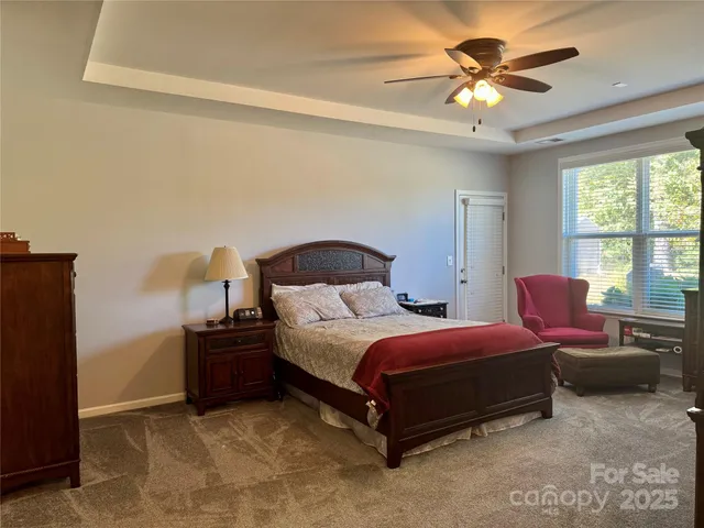 a spacious bedroom with a bed and window