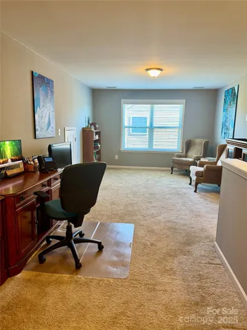 a living room with furniture rug and a window