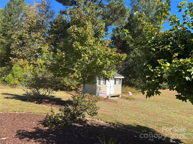 a view of house with backyard