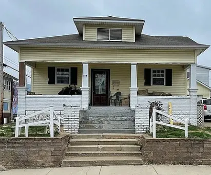 a front view of a house with a small yard