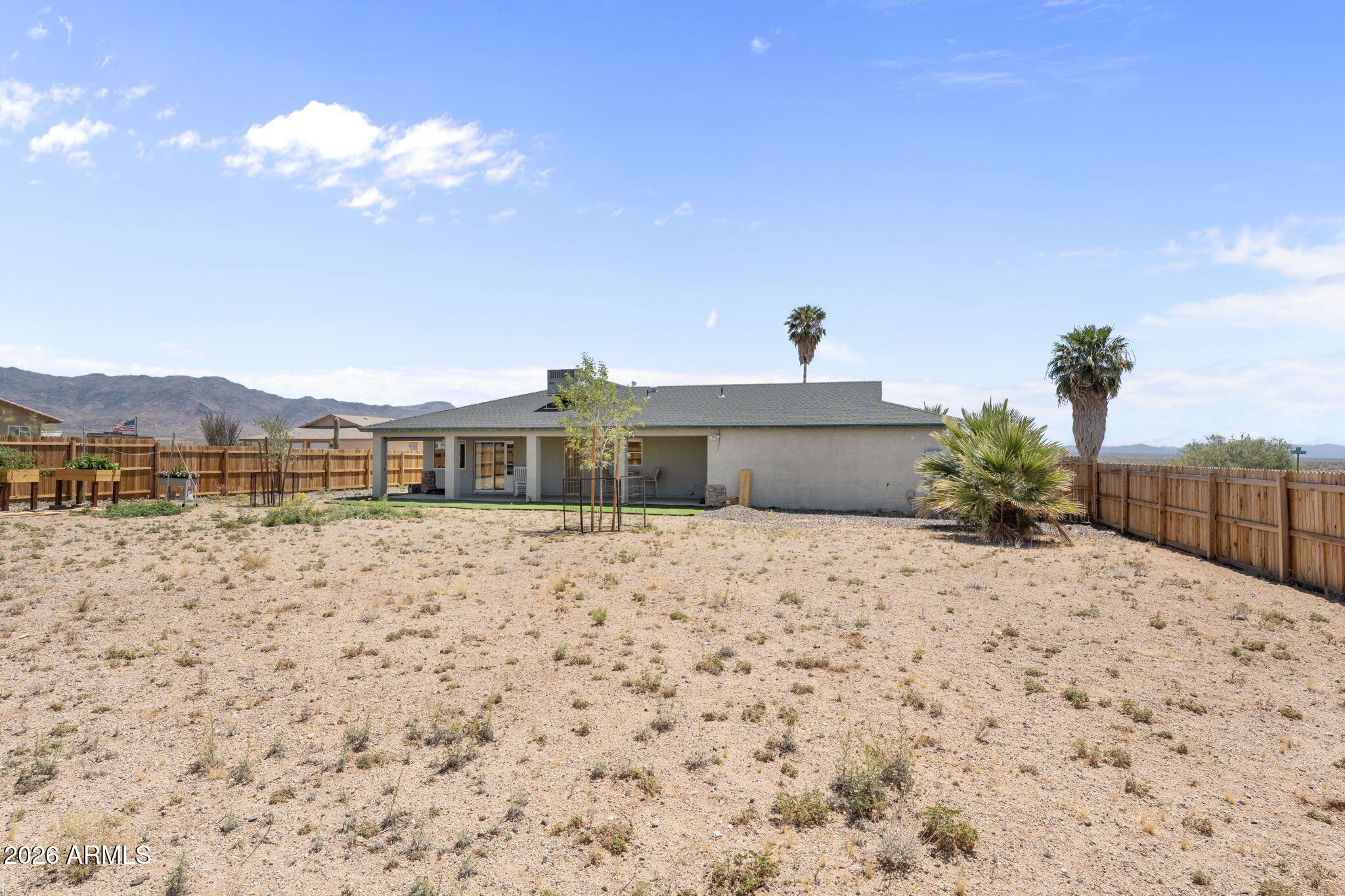27144 Bennett Way Congress, AZ 85332 - Photo 25 of 33 a bedroom with a bed and a chandelier