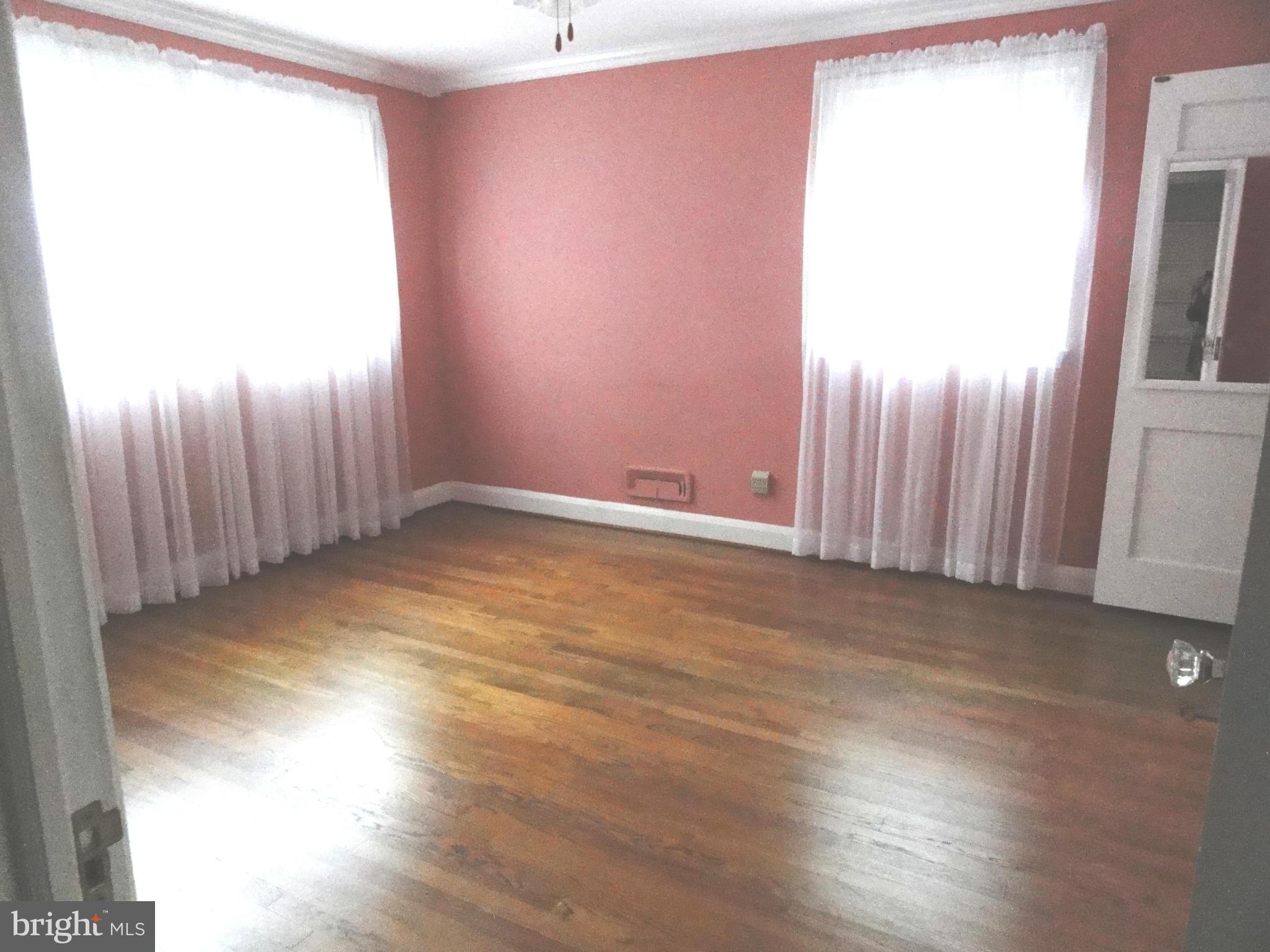 1501 Clairidge Road Baltimore, MD 21207 - Photo 13 of 28 Bedroom one with gleaning hardwood floors.