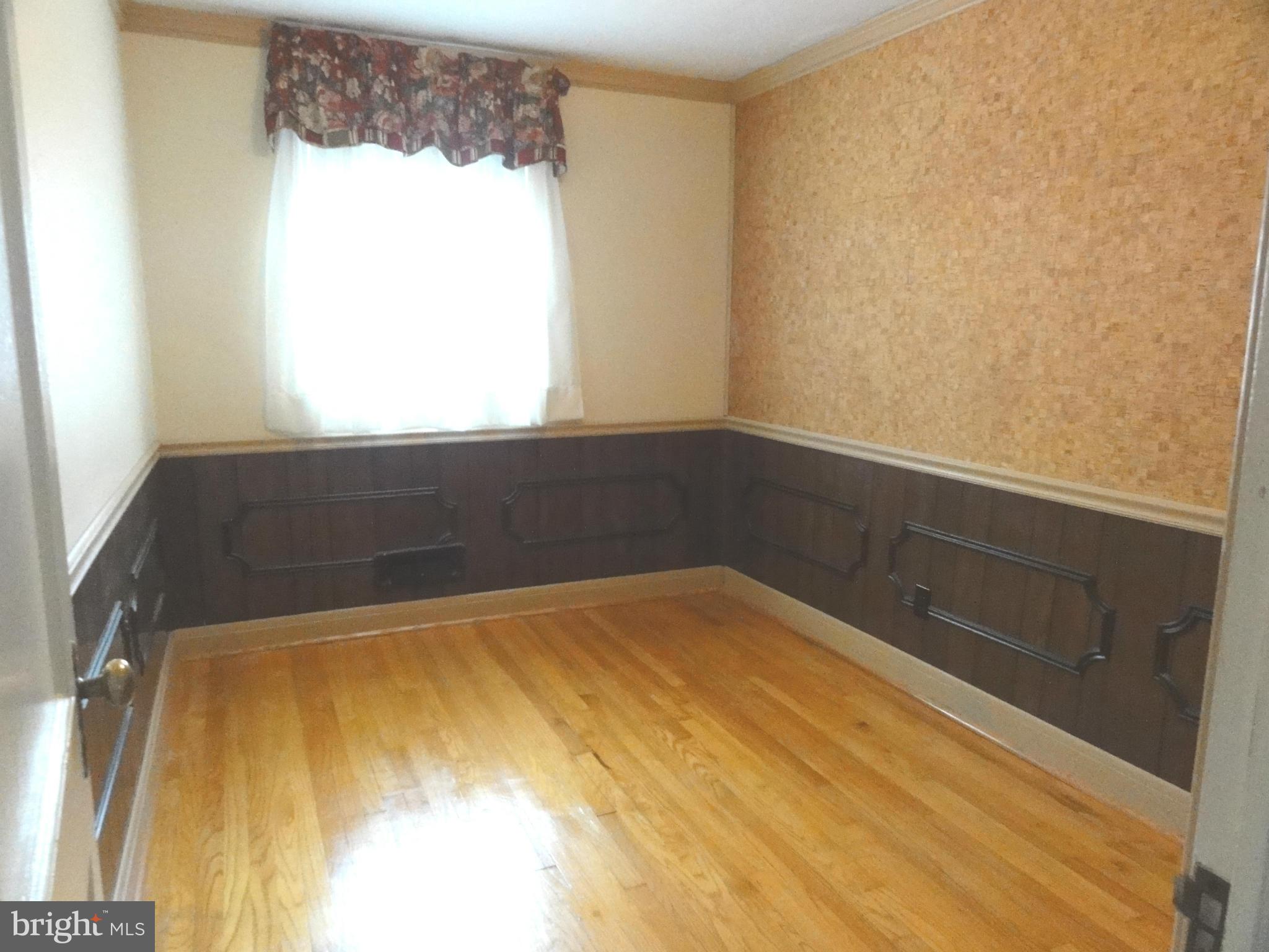 1501 Clairidge Road Baltimore, MD 21207 - Photo 14 of 28 Bedroom two with gleaning hardwood floors.