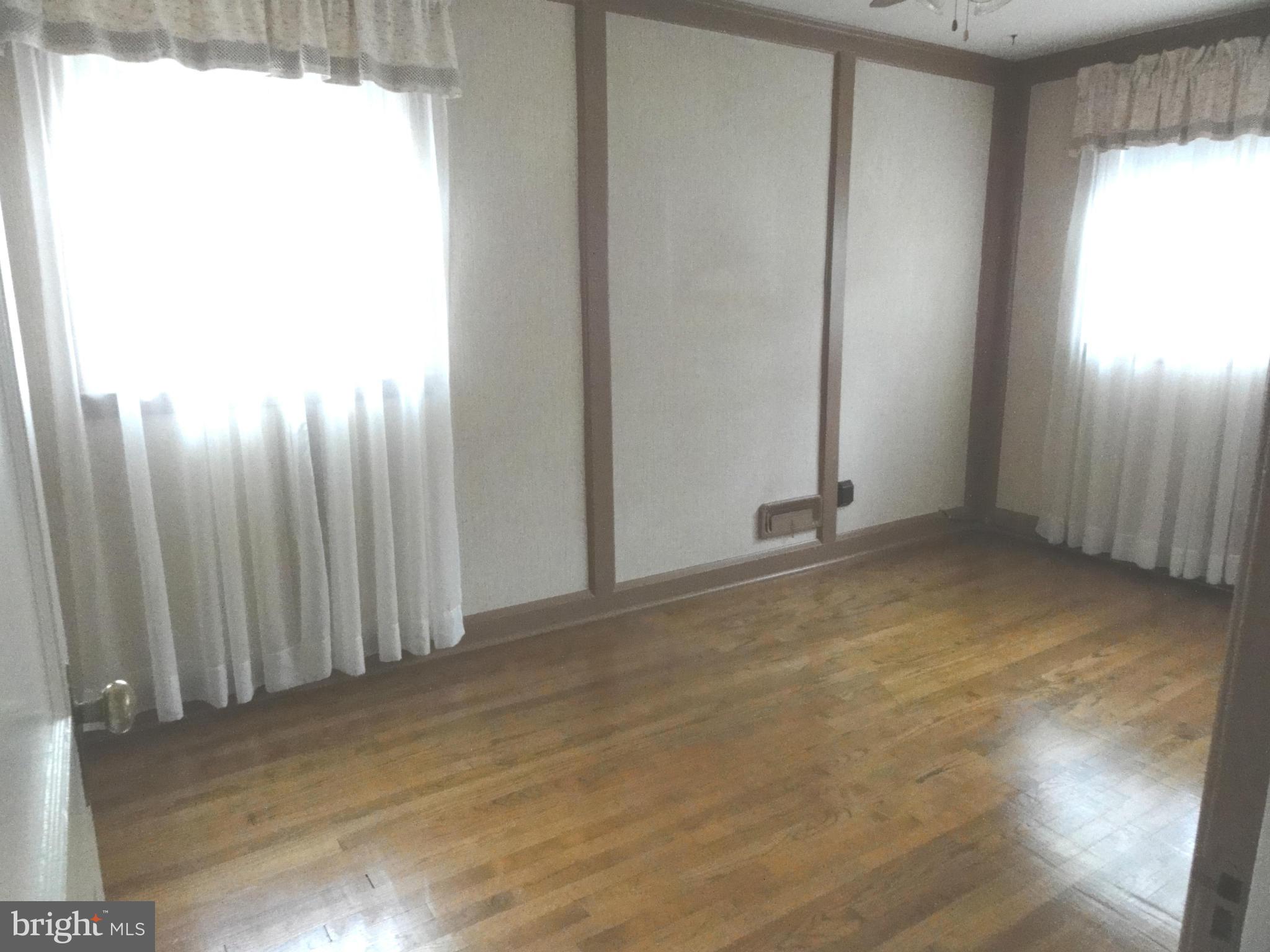 1501 Clairidge Road Baltimore, MD 21207 - Photo 15 of 28 Bedroom three with gleaning hardwood floors.
