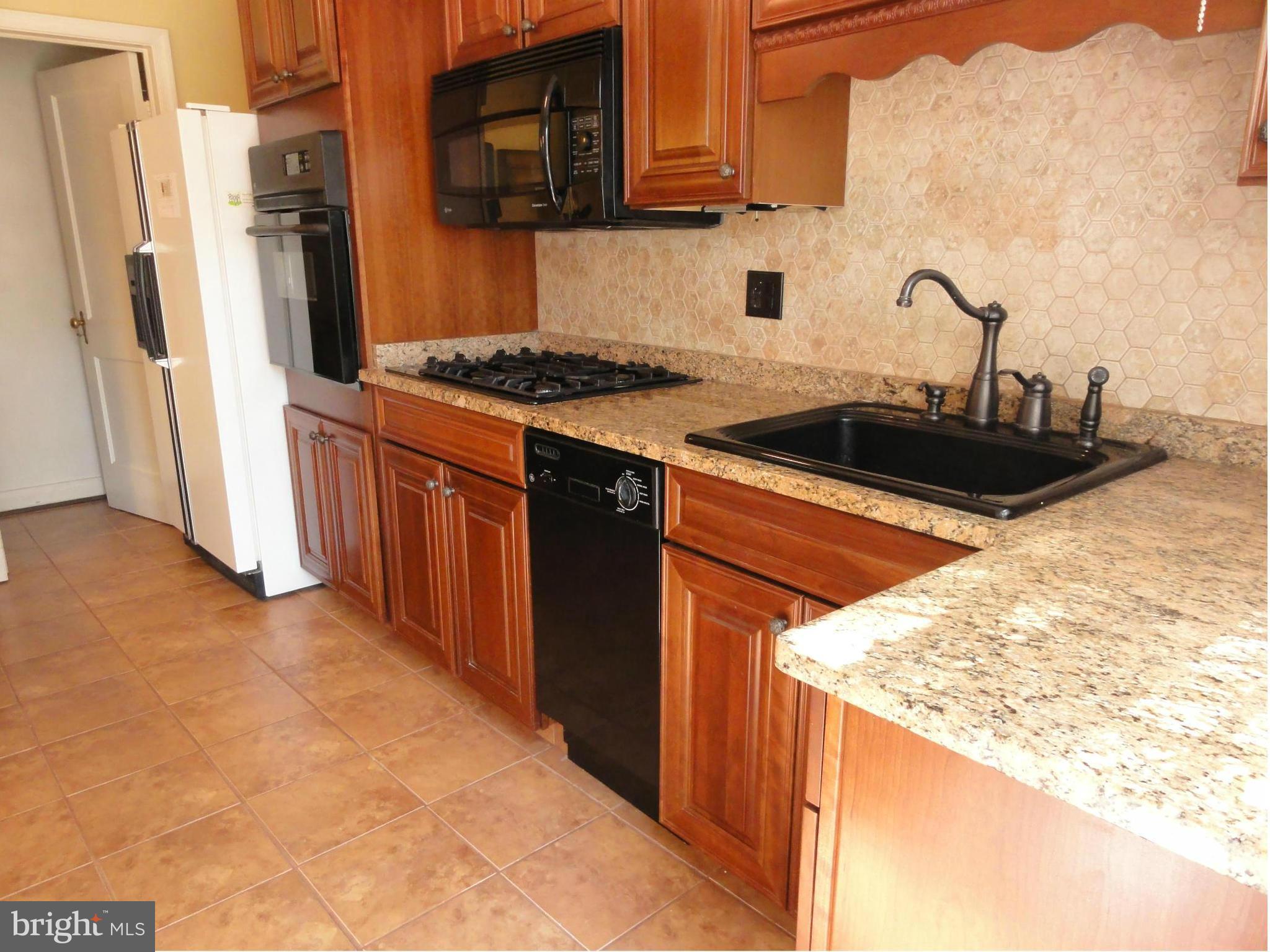 1501 Clairidge Road Baltimore, MD 21207 - Photo 3 of 28 Renovated kitchen with granite counters.