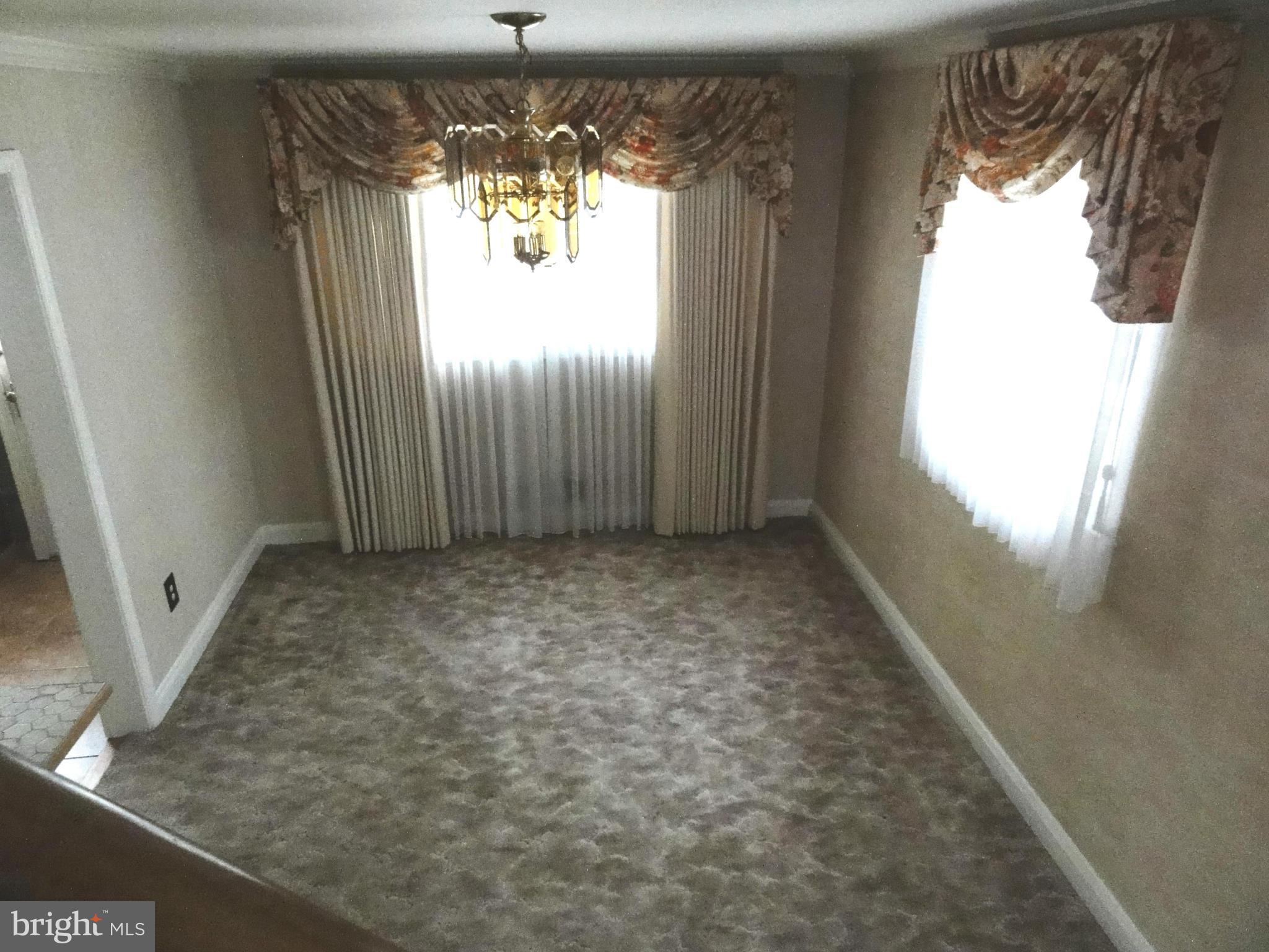 1501 Clairidge Road Baltimore, MD 21207 - Photo 10 of 28 Formal dining room with hardwood under carpet.