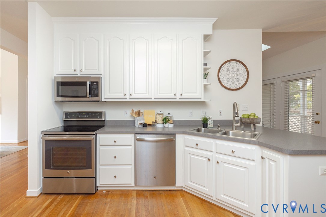 5713 Promontory Place Midlothian, VA 23112 - Photo 12 of 39 a kitchen with white cabinets and stainless steel appliances