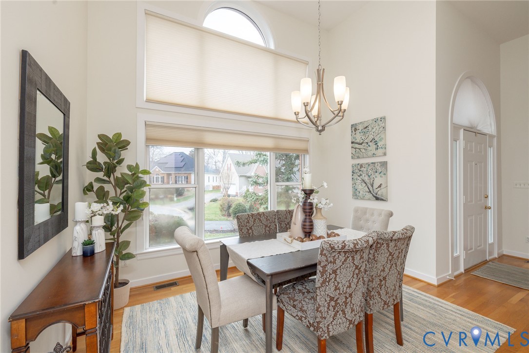 5713 Promontory Place Midlothian, VA 23112 - Photo 17 of 39 a dining room with furniture a chandelier and wooden floor