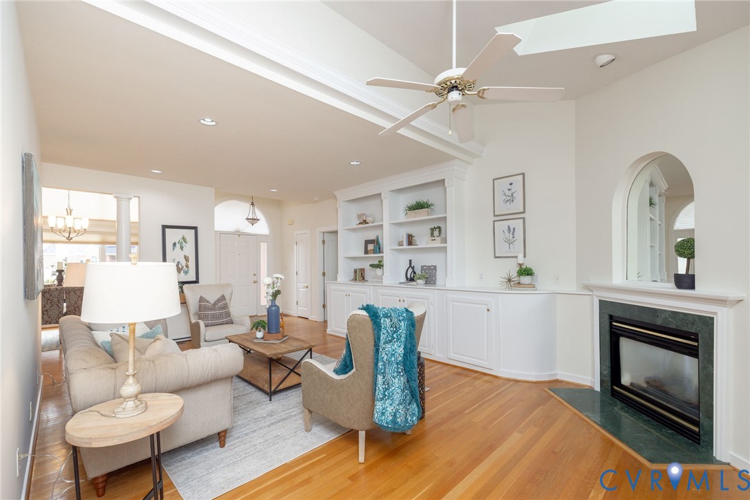 5713 Promontory Place Midlothian, VA 23112 - Photo 7 of 39 a living room with furniture a fireplace and a large window