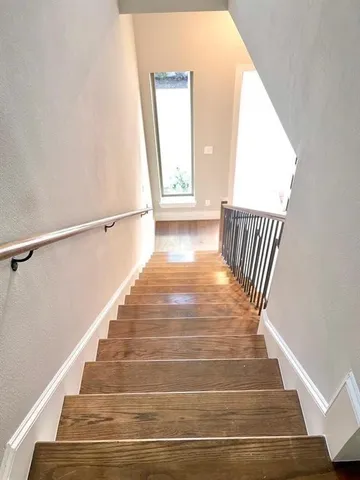 a view of entryway and hall with wooden floor