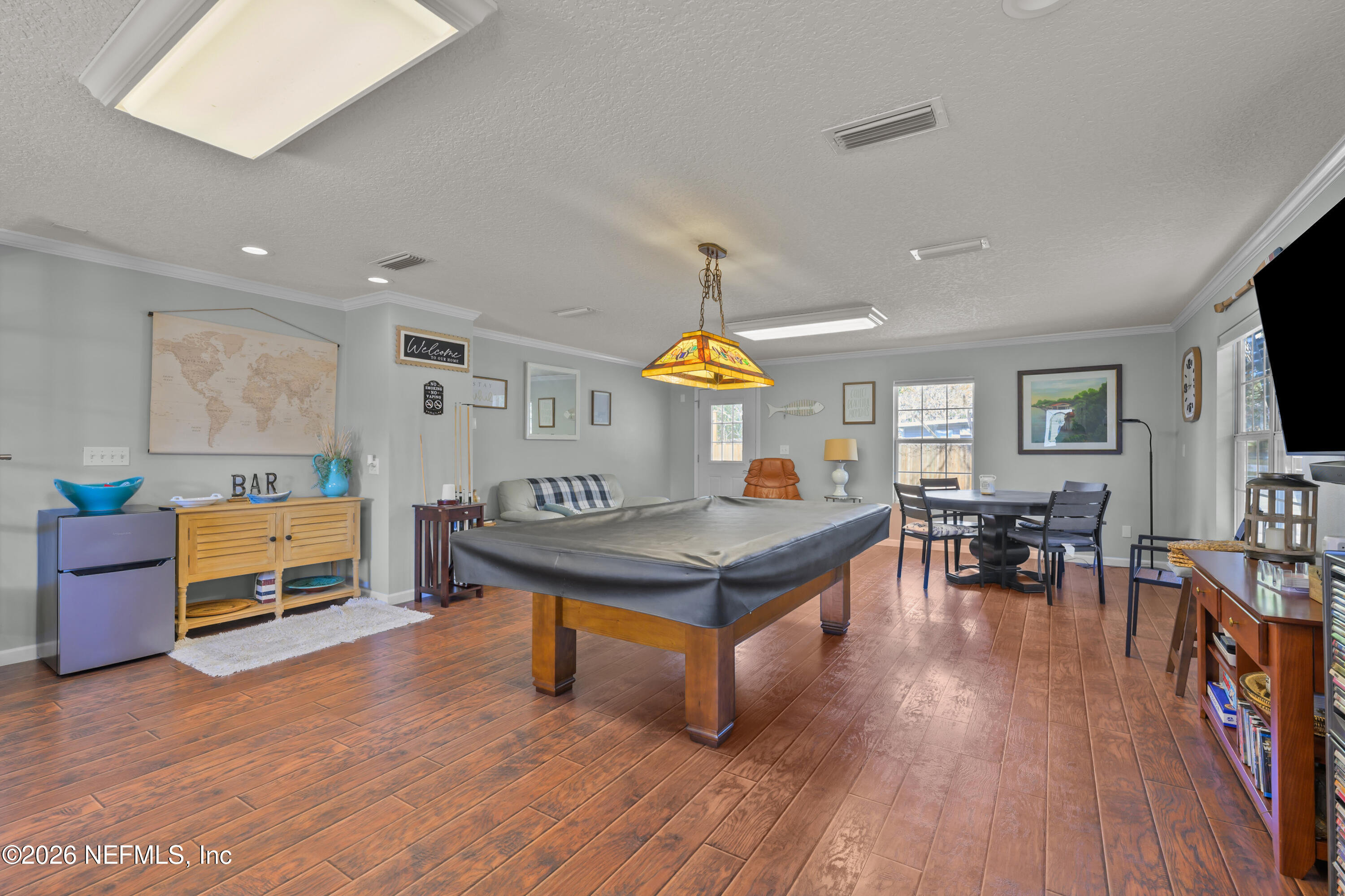 253 Hess Road Crescent City, FL 32112 - Photo 11 of 38 a living room with furniture kitchen view and a wooden floor