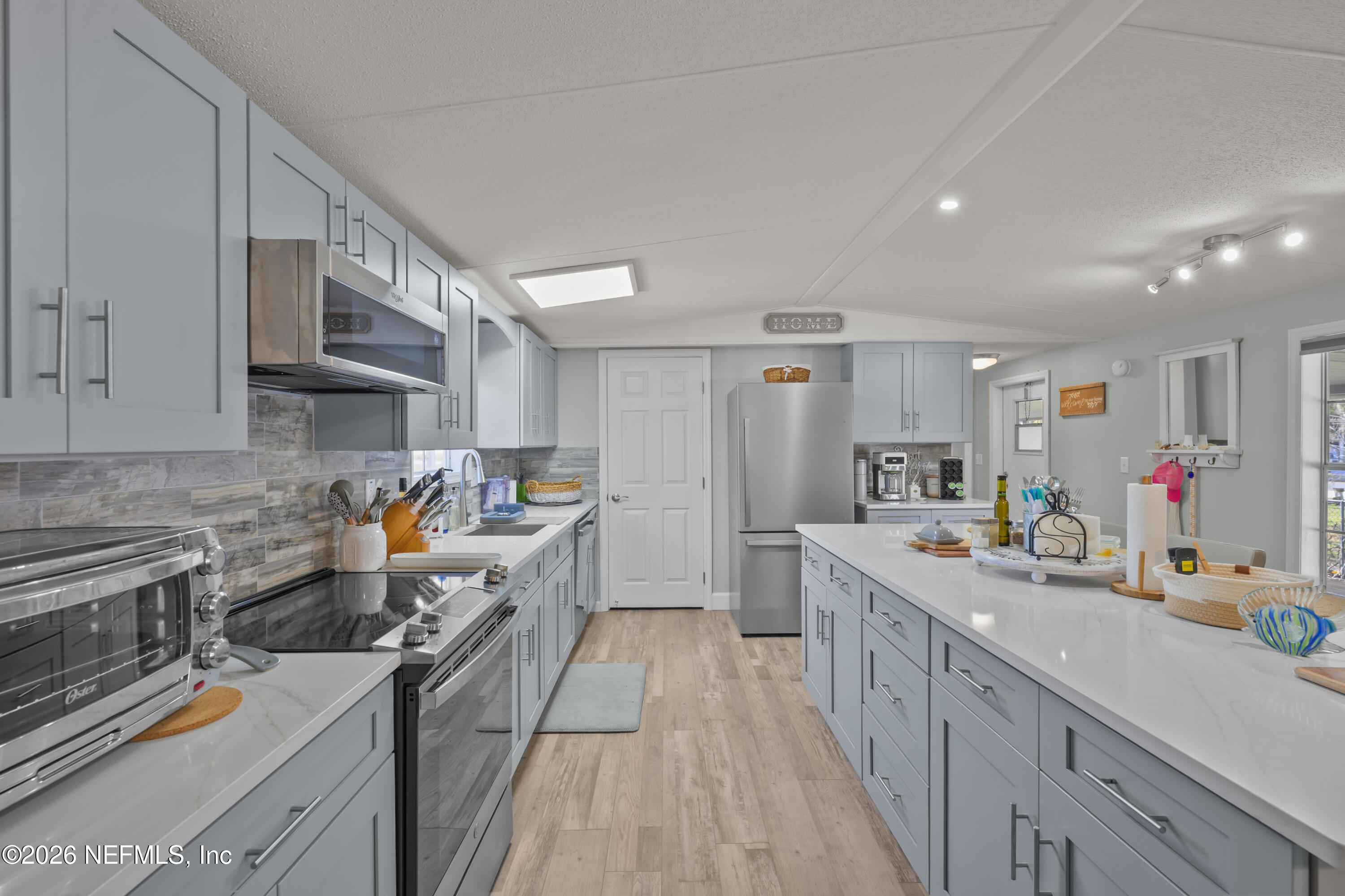 253 Hess Road Crescent City, FL 32112 - Photo 15 of 38 a kitchen that has a lot of cabinets in it and wooden floors