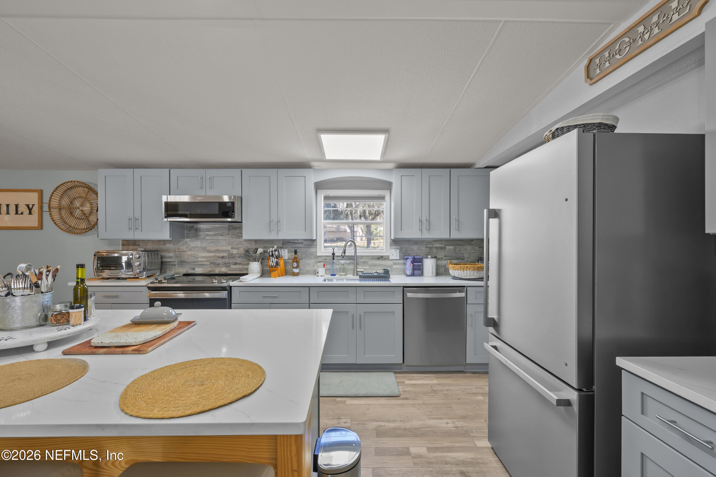 253 Hess Road Crescent City, FL 32112 - Photo 16 of 38 a kitchen with stainless steel appliances granite countertop a refrigerator a stove top oven a sink and dishwasher