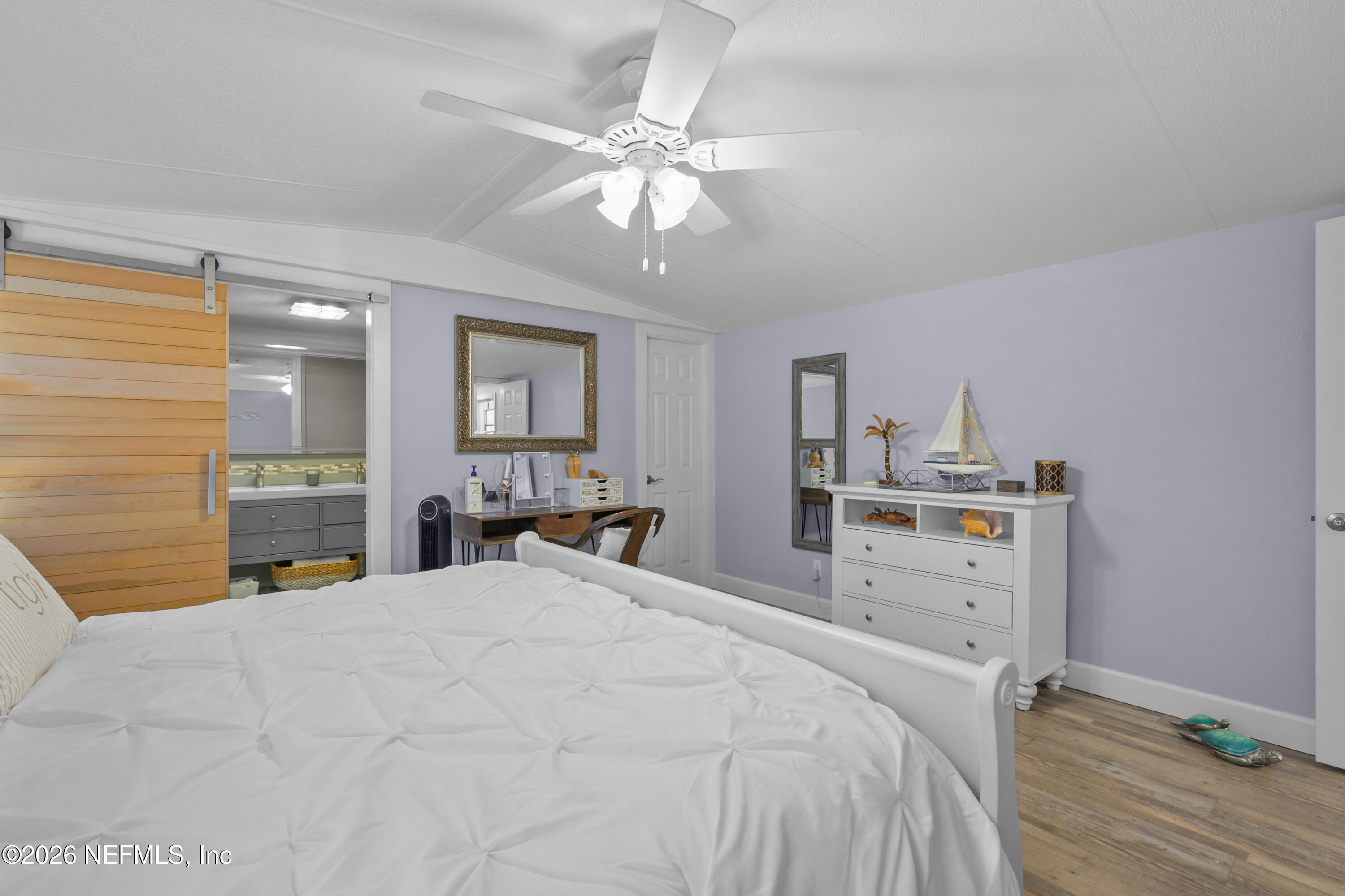 253 Hess Road Crescent City, FL 32112 - Photo 26 of 38 a large bedroom with a bed and a chandelier