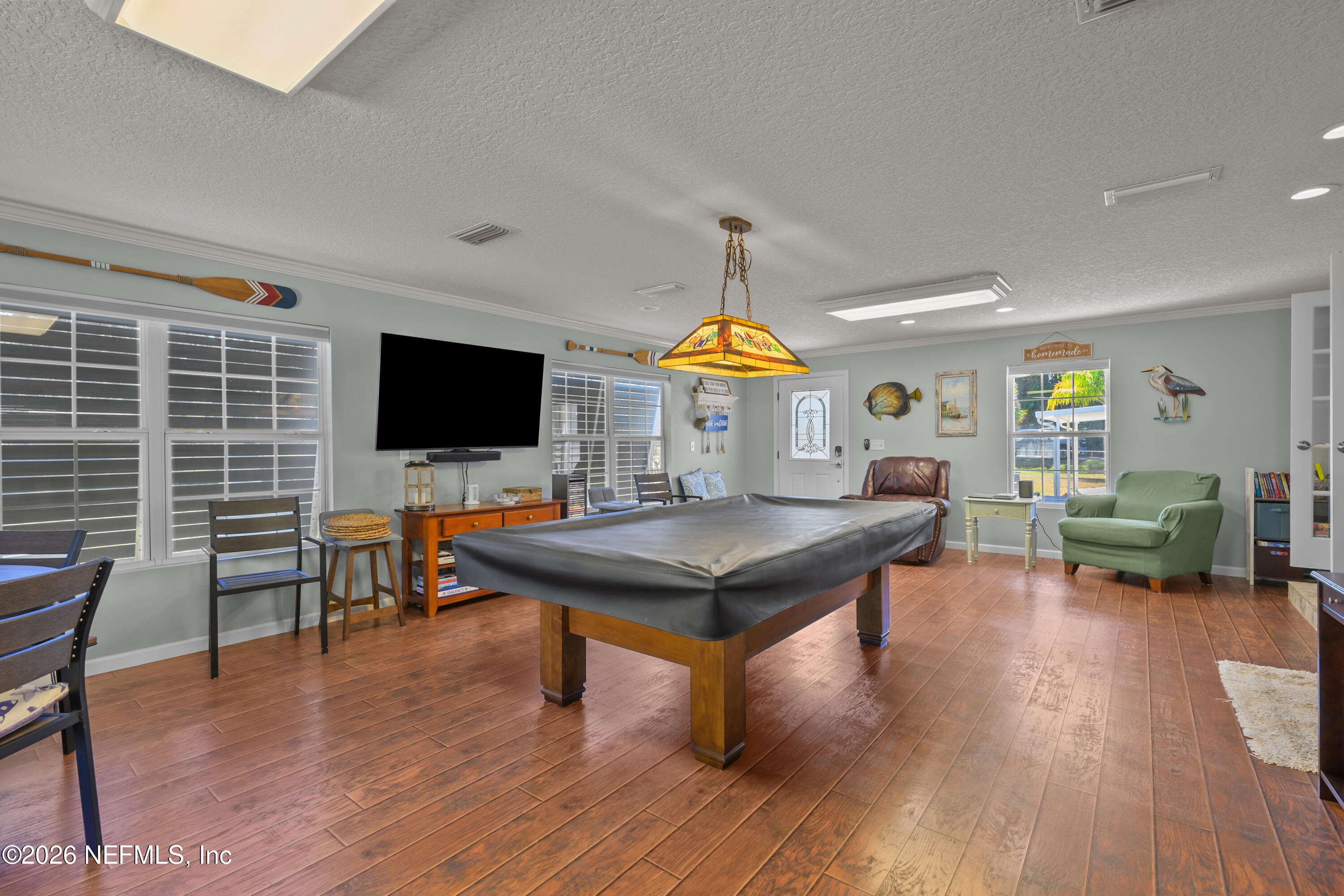 253 Hess Road Crescent City, FL 32112 - Photo 3 of 38 a living room with furniture a flat screen tv and kitchen view