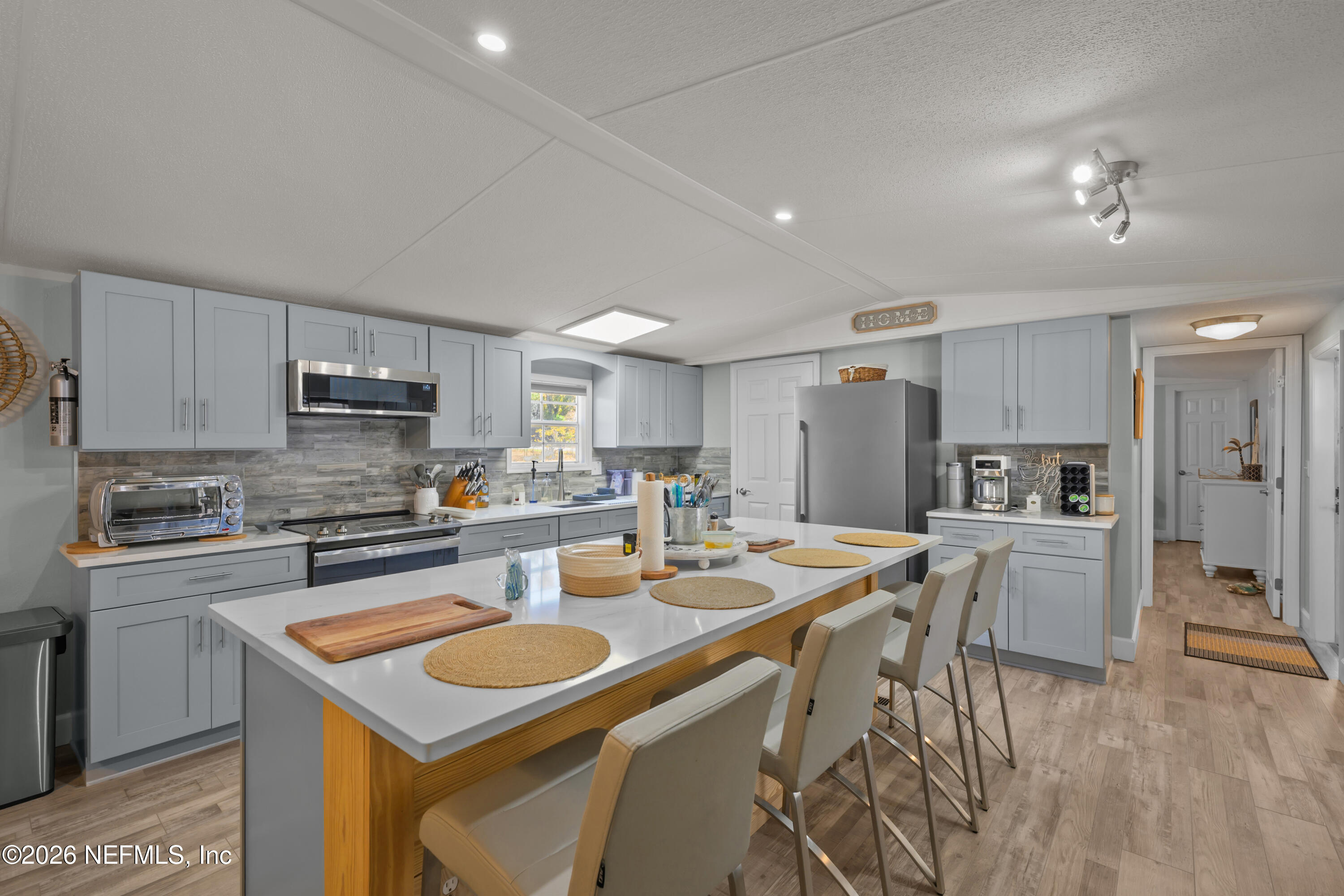 253 Hess Road Crescent City, FL 32112 - Photo 4 of 38 a kitchen with white cabinets stainless steel appliances and sink