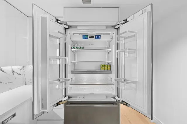 a view of walk in closet and bathroom