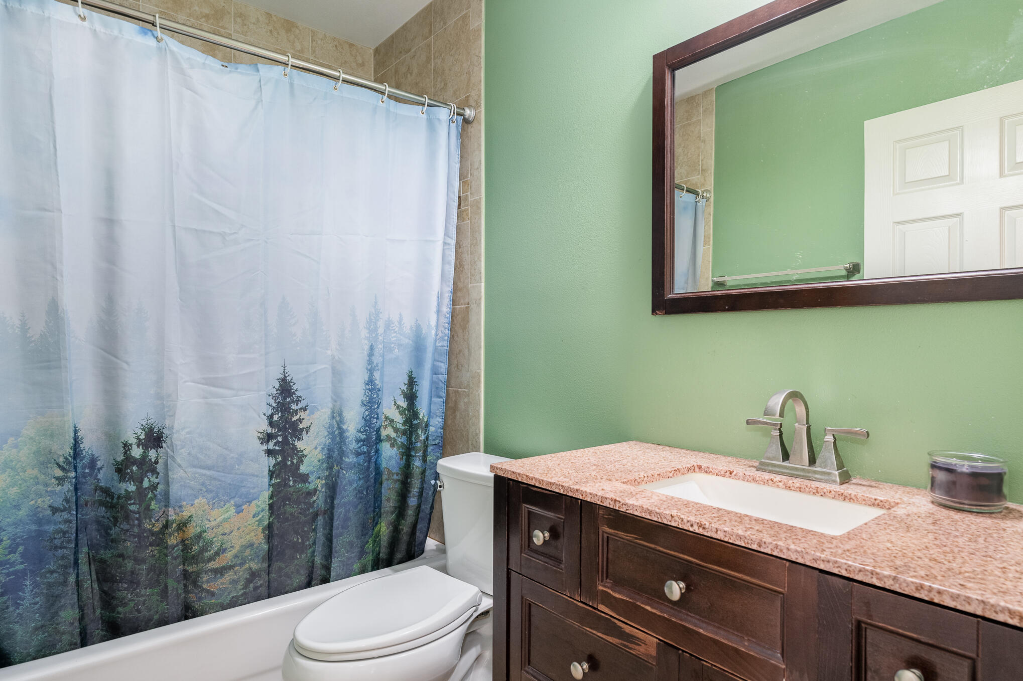 1908 Glendon Drive Melbourne, FL 32901 - Photo 21 of 26 a bathroom with a granite countertop toilet sink and mirror