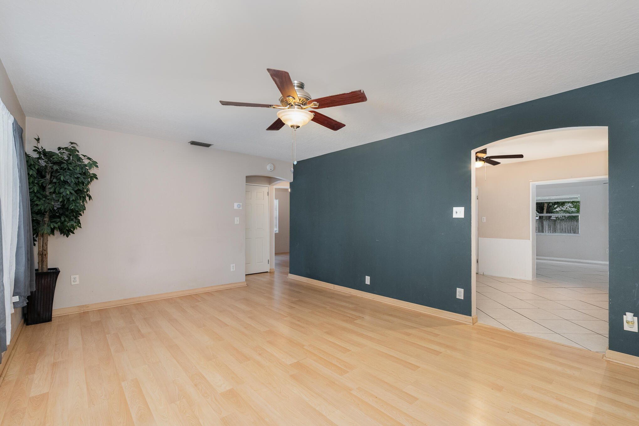 1908 Glendon Drive Melbourne, FL 32901 - Photo 6 of 26 a view of empty room with wooden floor and ceiling fan