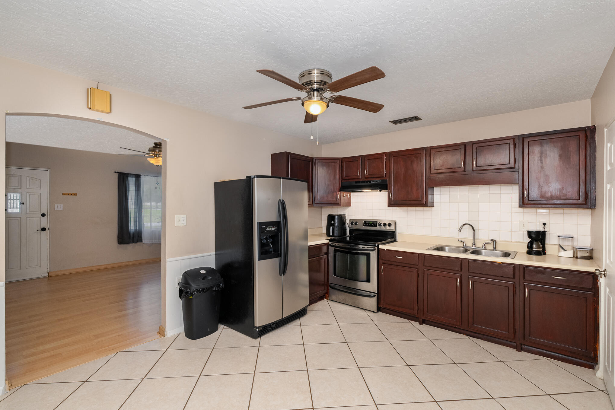 1908 Glendon Drive Melbourne, FL 32901 - Photo 7 of 26 a kitchen with stainless steel appliances granite countertop a refrigerator a sink a stove top oven and a sink