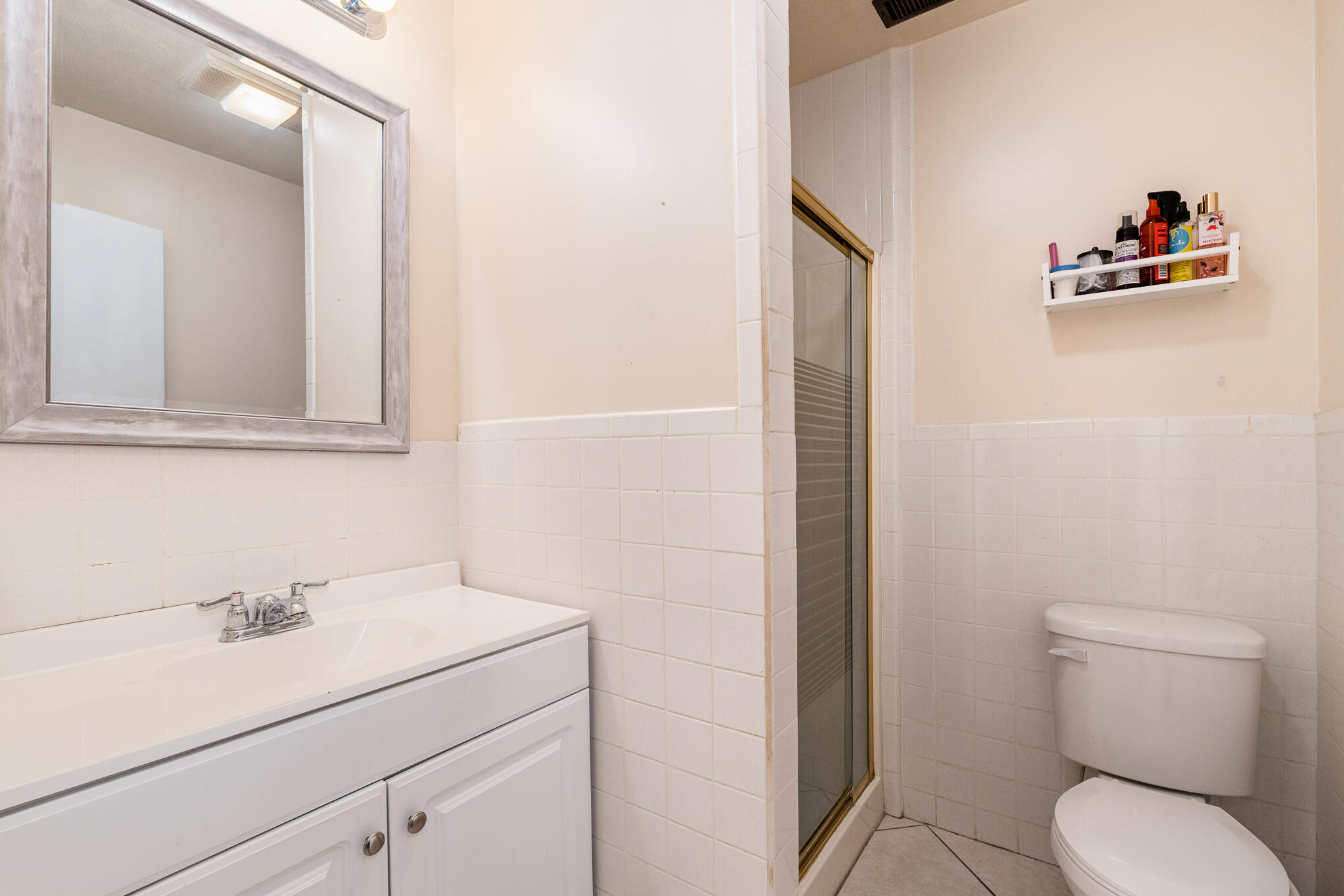 1908 Glendon Drive Melbourne, FL 32901 - Photo 8 of 26 a bathroom with a toilet sink and mirror