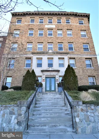 a front view of a building with garden