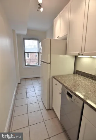 a kitchen with a sink a refrigerator and window