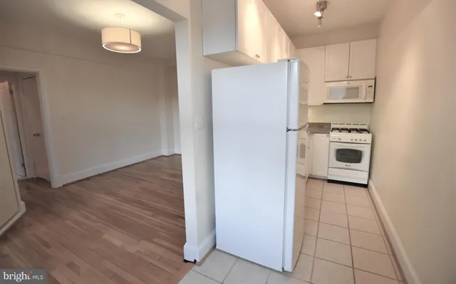 a kitchen with a refrigerator and a stove