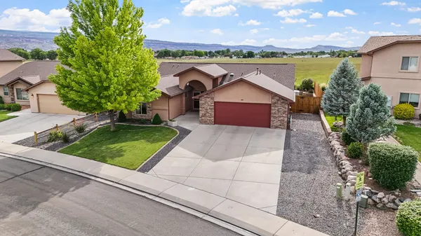 a view of a house with pool and a yard