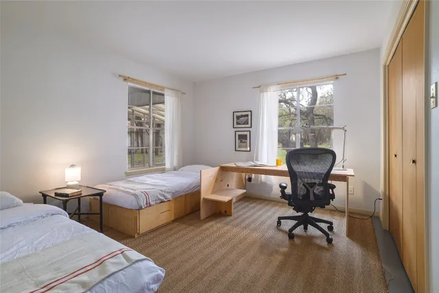 a bedroom with bed and window