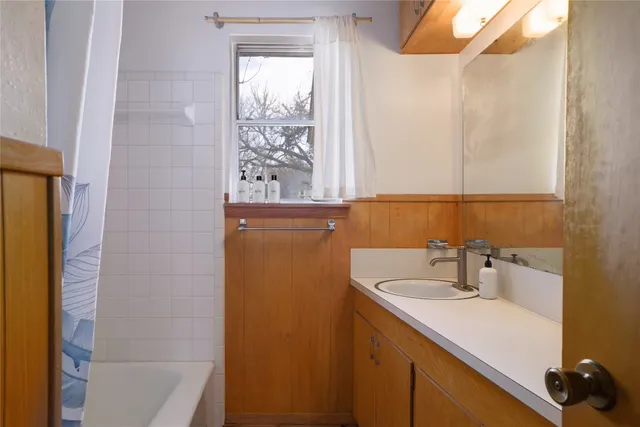 a view of a room with wooden floor and windows