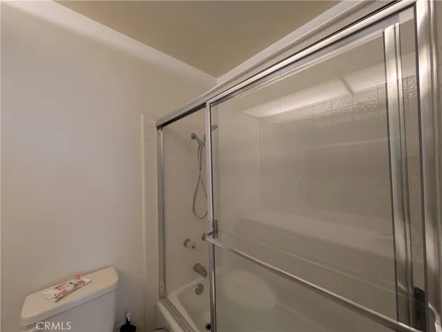 a bathroom with a glass shower door