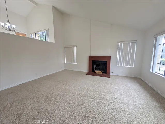 a view of empty room with a fireplace
