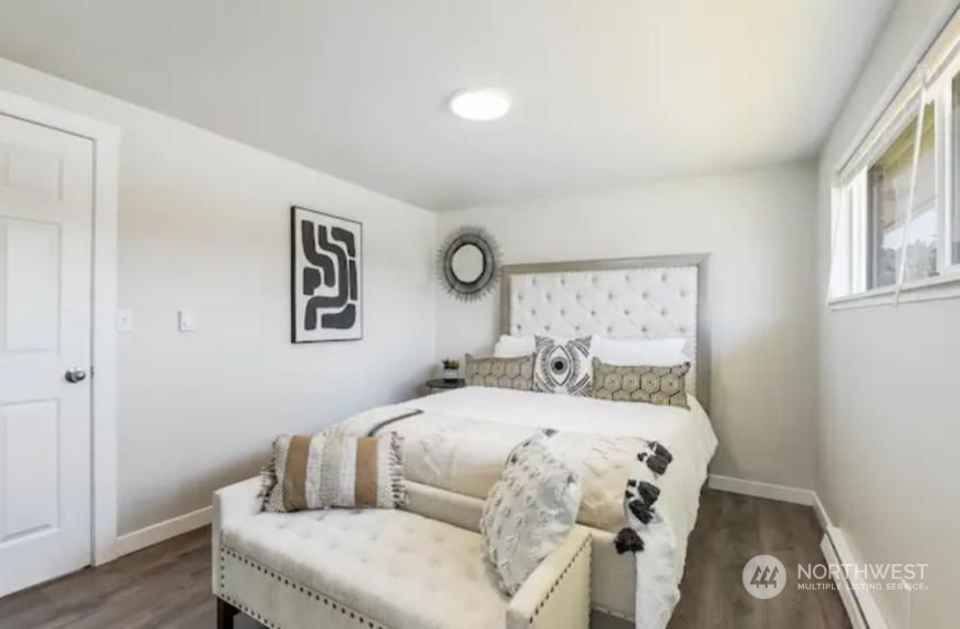 602 South 5th Street Renton, WA 98057 - Photo 12 of 27 a bedroom with a bed and wooden floor