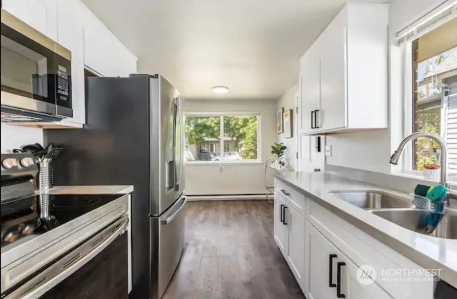 602 South 5th Street Renton, WA 98057 - Photo 19 of 27 a kitchen with stainless steel appliances granite countertop a sink stove and refrigerator