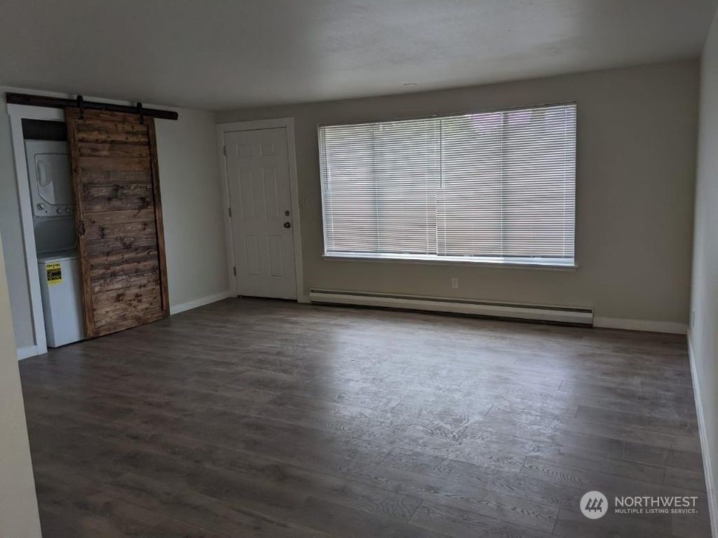 602 South 5th Street Renton, WA 98057 - Photo 23 of 27 an empty room with wooden floor and windows