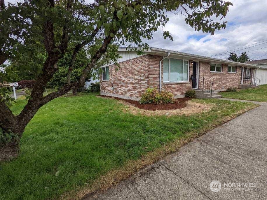 602 South 5th Street Renton, WA 98057 - Photo 3 of 27 a view of a house with a yard potted plants and large tree