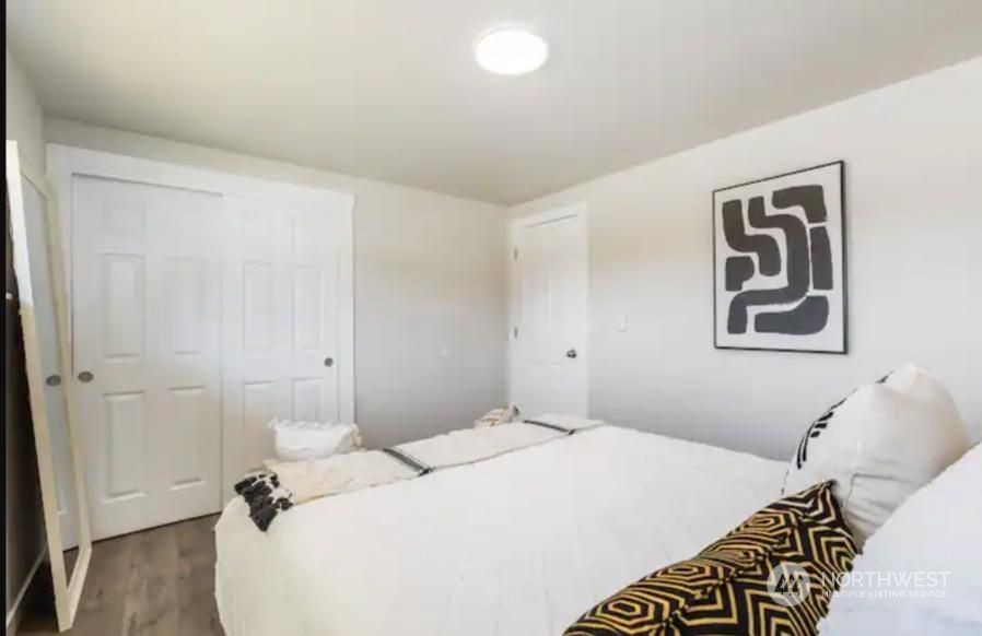 602 South 5th Street Renton, WA 98057 - Photo 5 of 27 a bedroom with a bed and a painting on the wall