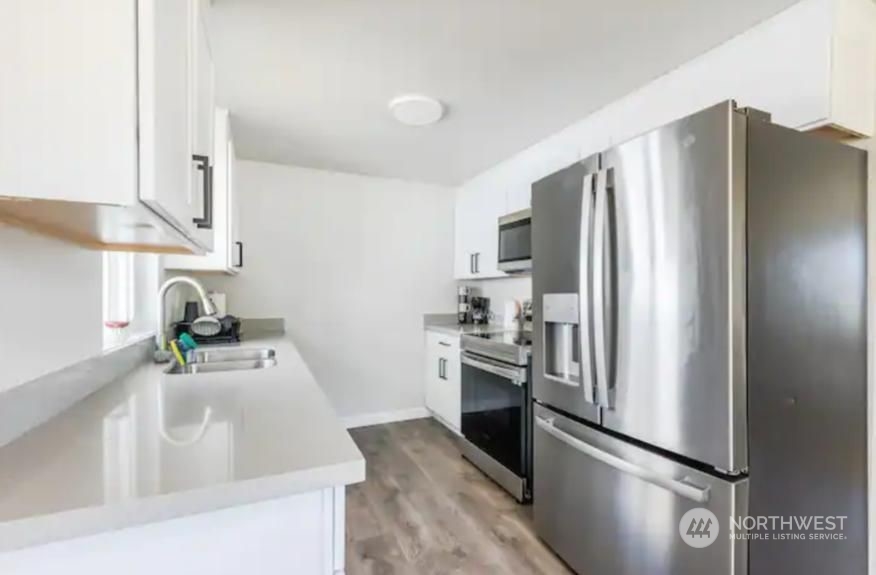 602 South 5th Street Renton, WA 98057 - Photo 7 of 27 a kitchen with stainless steel appliances granite countertop a refrigerator and a sink