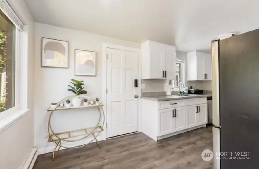 602 South 5th Street Renton, WA 98057 - Photo 9 of 27 a kitchen with granite countertop white cabinets and white appliances