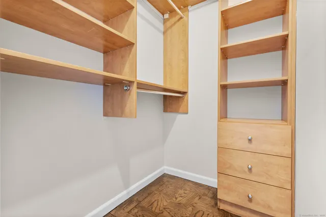 a view of walk in closet with empty racks