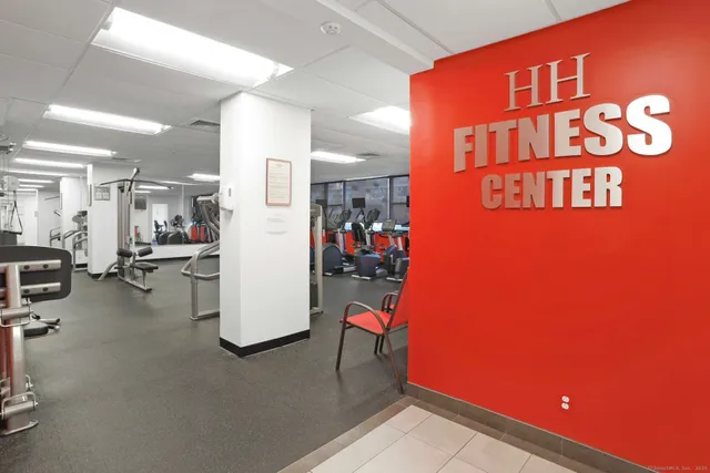 a room with gym equipment and a view of living room