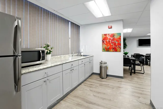 a kitchen with stainless steel appliances a refrigerator and a stove top oven