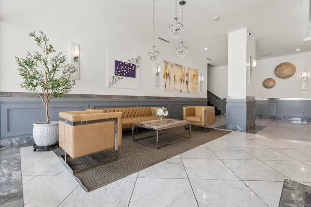 a living room with furniture and a clock